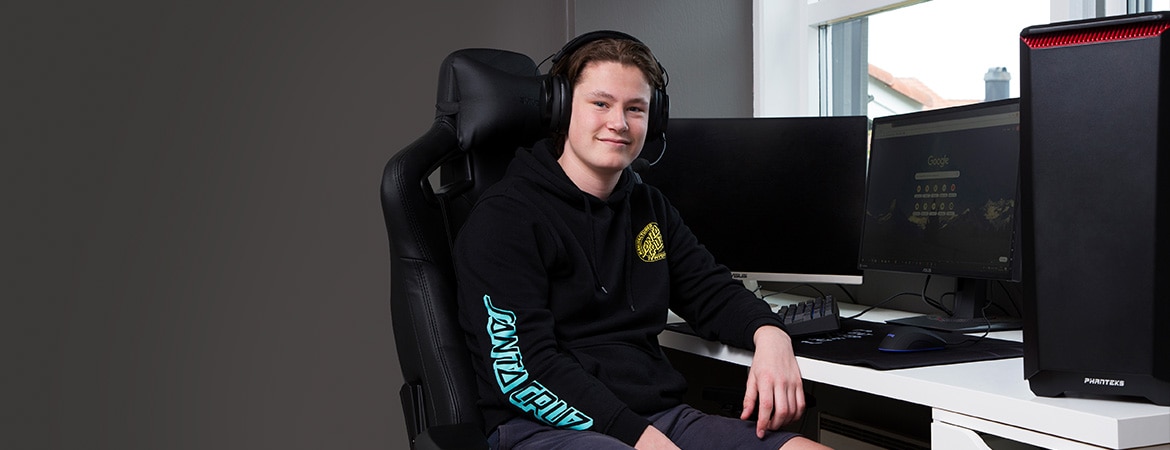 Ola framför sin egenbyggda Gaming-PC köpt med konfirmationspengarna.